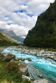 blue flowing river among mountains and rocks